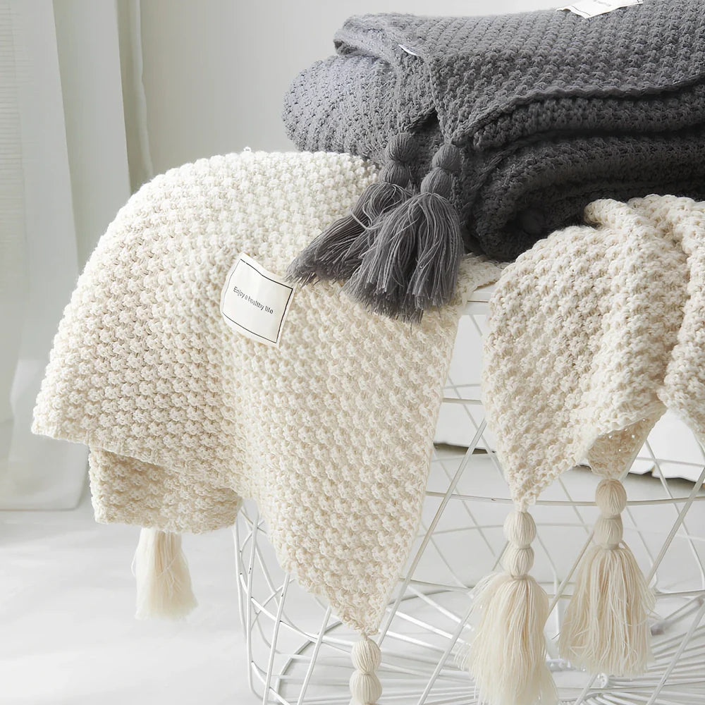 Fringed knitting blanket in beige colour showing 5cm fringe detailing and dense acrylic weave texture
