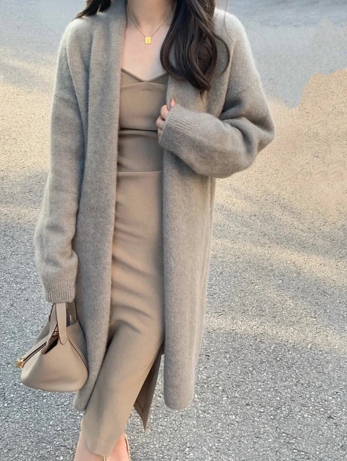 Women's knitted cardigan with V-neck and long sleeves in khaki colour, showing mid-length design