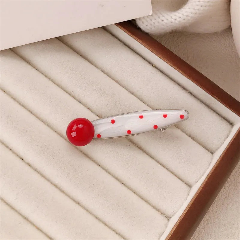 Red love heart-shaped hair barrette clip with retro white dots on a willow leaf-shaped base.
