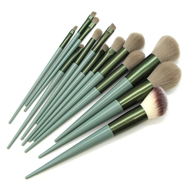13 green makeup brushes with plastic handles and aluminium ferrules arranged with storage bag
