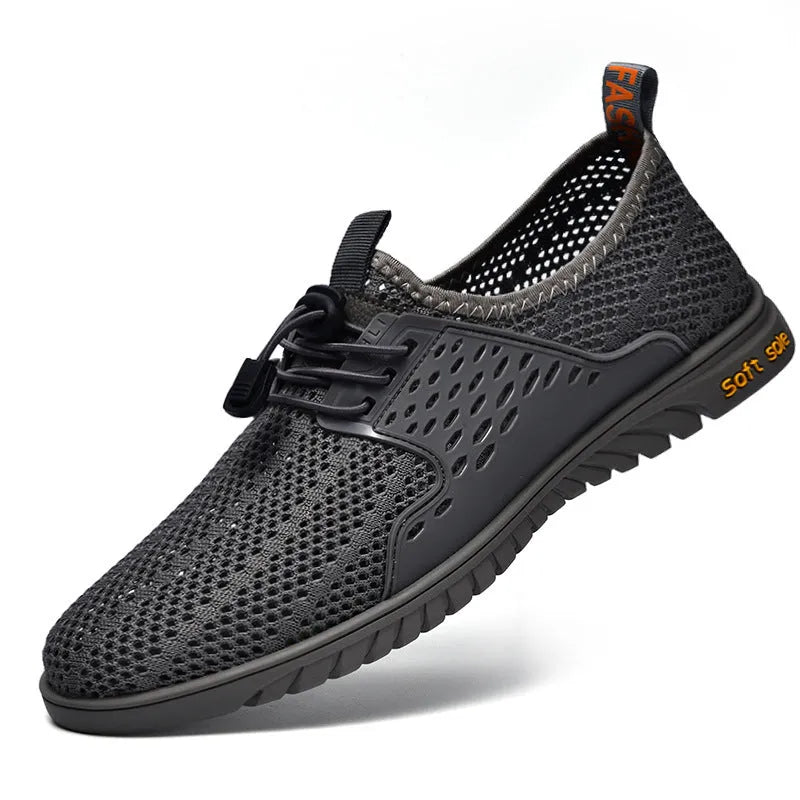 Men's black breathable mesh casual shoe with elastic band and rubber sole on a white background.