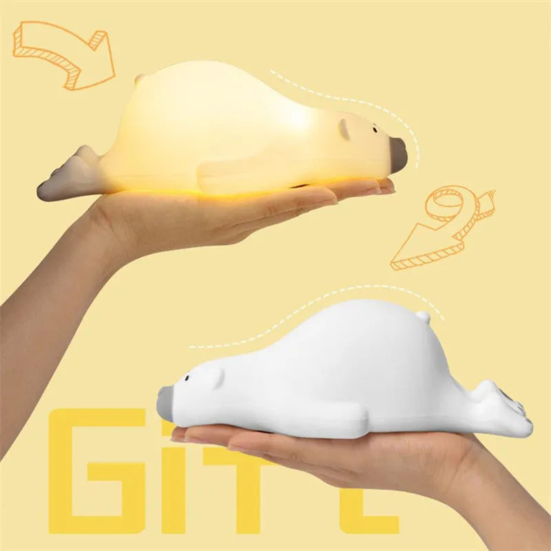 White bear-shaped silicone night light on a table with USB cable.
