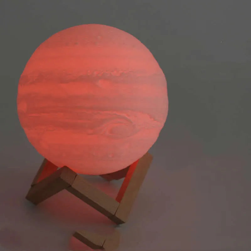 3D printed white moon lamp on a wooden holder, showing detailed crater texture and soft LED glow.