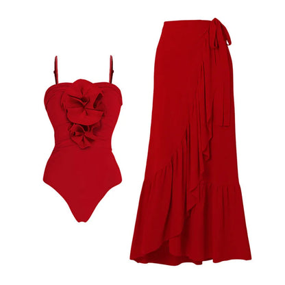Red women's V-neck halter swimsuit with open back and a matching detachable long skirt laid flat.