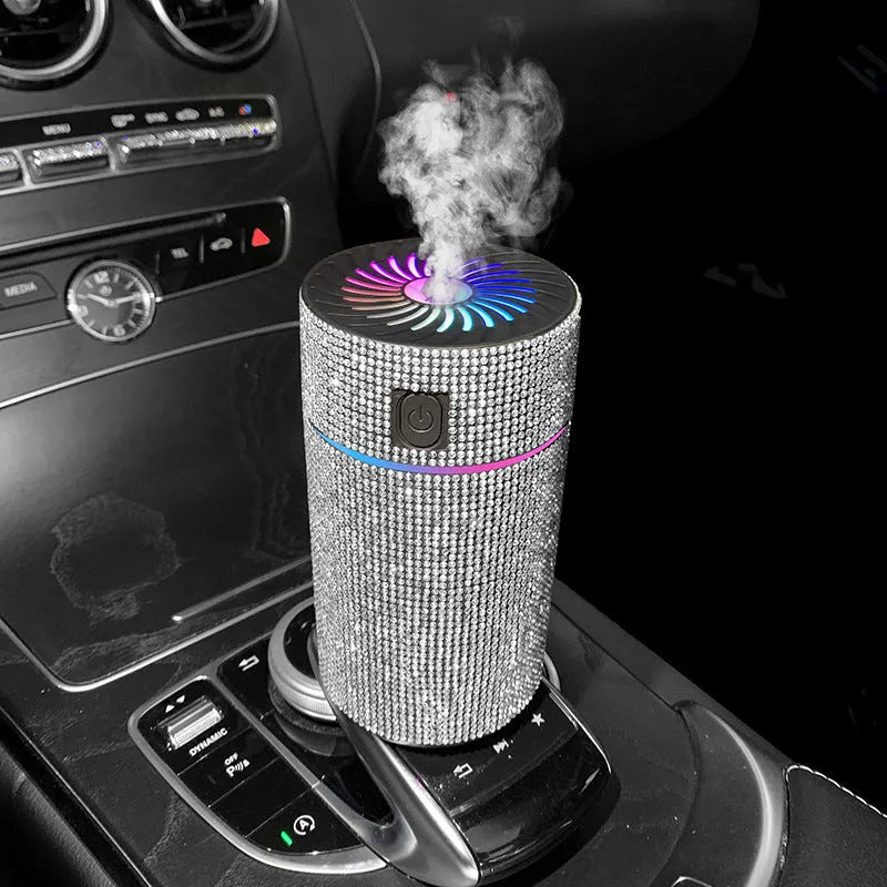 Compact white car air purifier and humidifier unit with USB cable on a car dashboard.