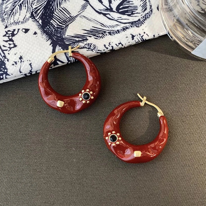 Retro-style alloy ear studs with rhinestone inlay and dripping oil finish in black and red options