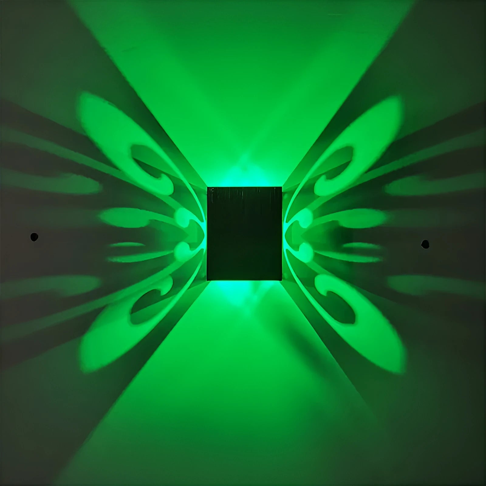 Modern aluminium butterfly-shaped LED wall lamp with colour-changing lights on a plain wall