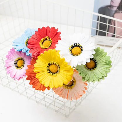 Silk artificial flower bouquet in a white polyurethane pot on a wooden table.