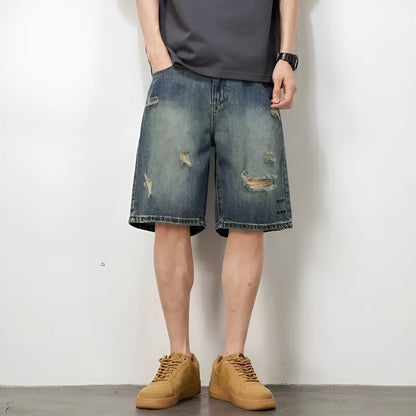 Men's blue loose fit denim shorts with distressed holes and straight leg