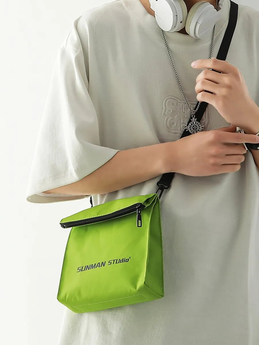 Polyester Oxford fabric messenger-style backpack in khaki colour with visible stitching and a crossbody strap.