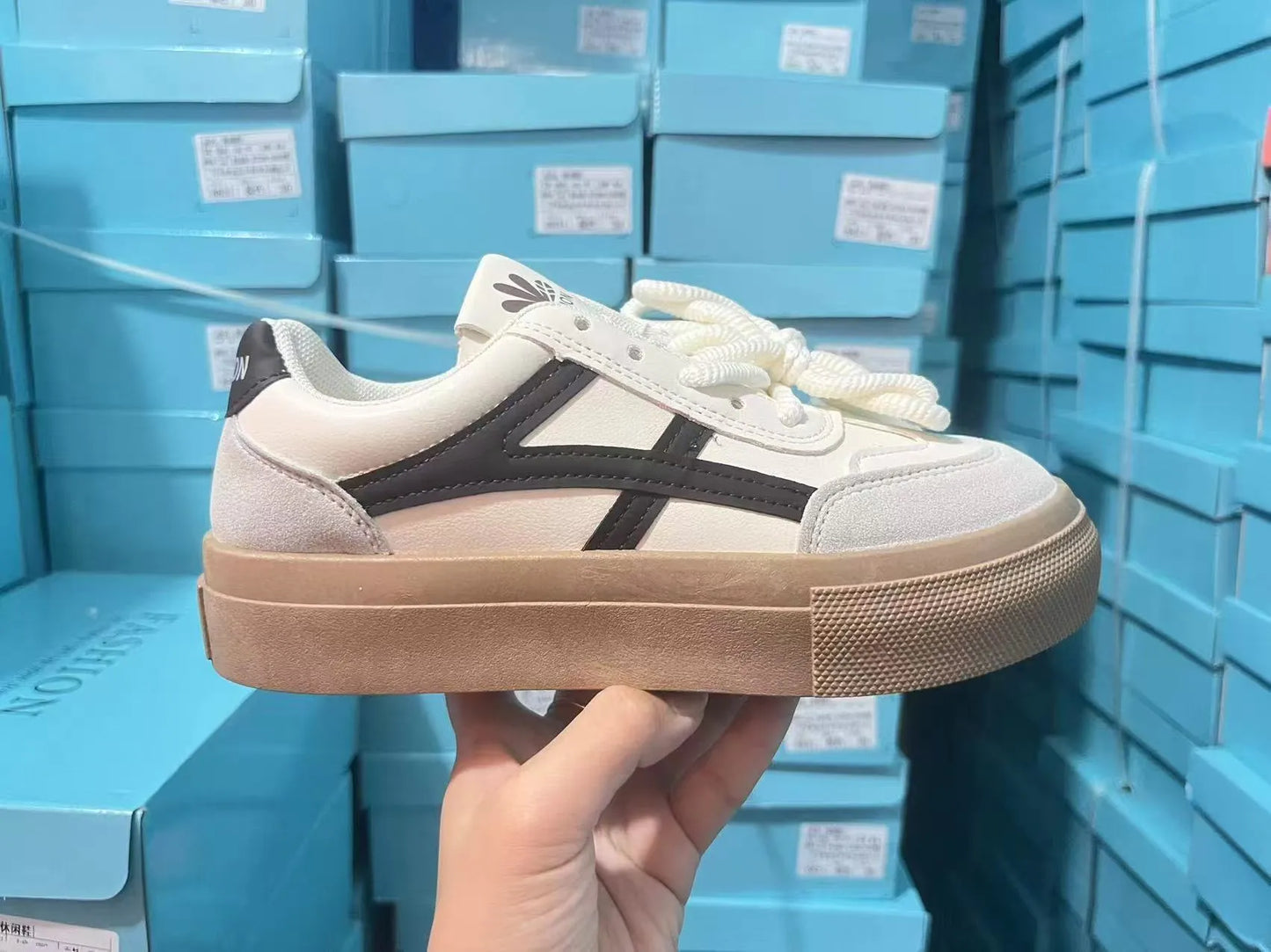 Low-top blue and brown casual lace-up shoes with round toe and flat rubber sole.