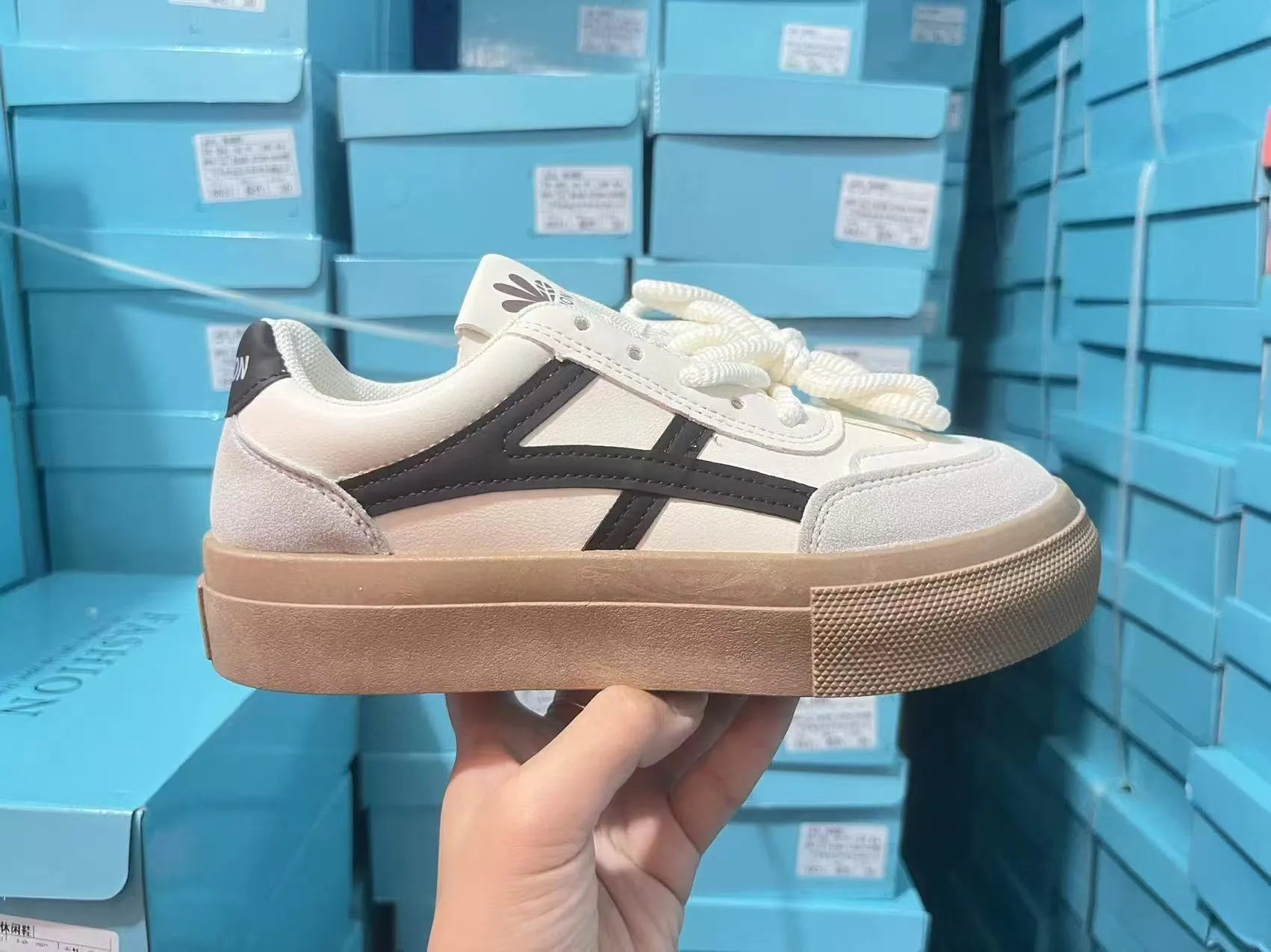 Low-top blue and brown casual lace-up shoes with round toe and flat rubber sole.