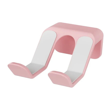 Black ABS plastic universal wall hanging rack for game controllers with adhesive pad and screws.