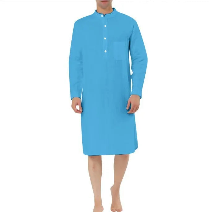 Man wearing a dark blue cotton shirt robe with button front, long sleeves, and side pockets.