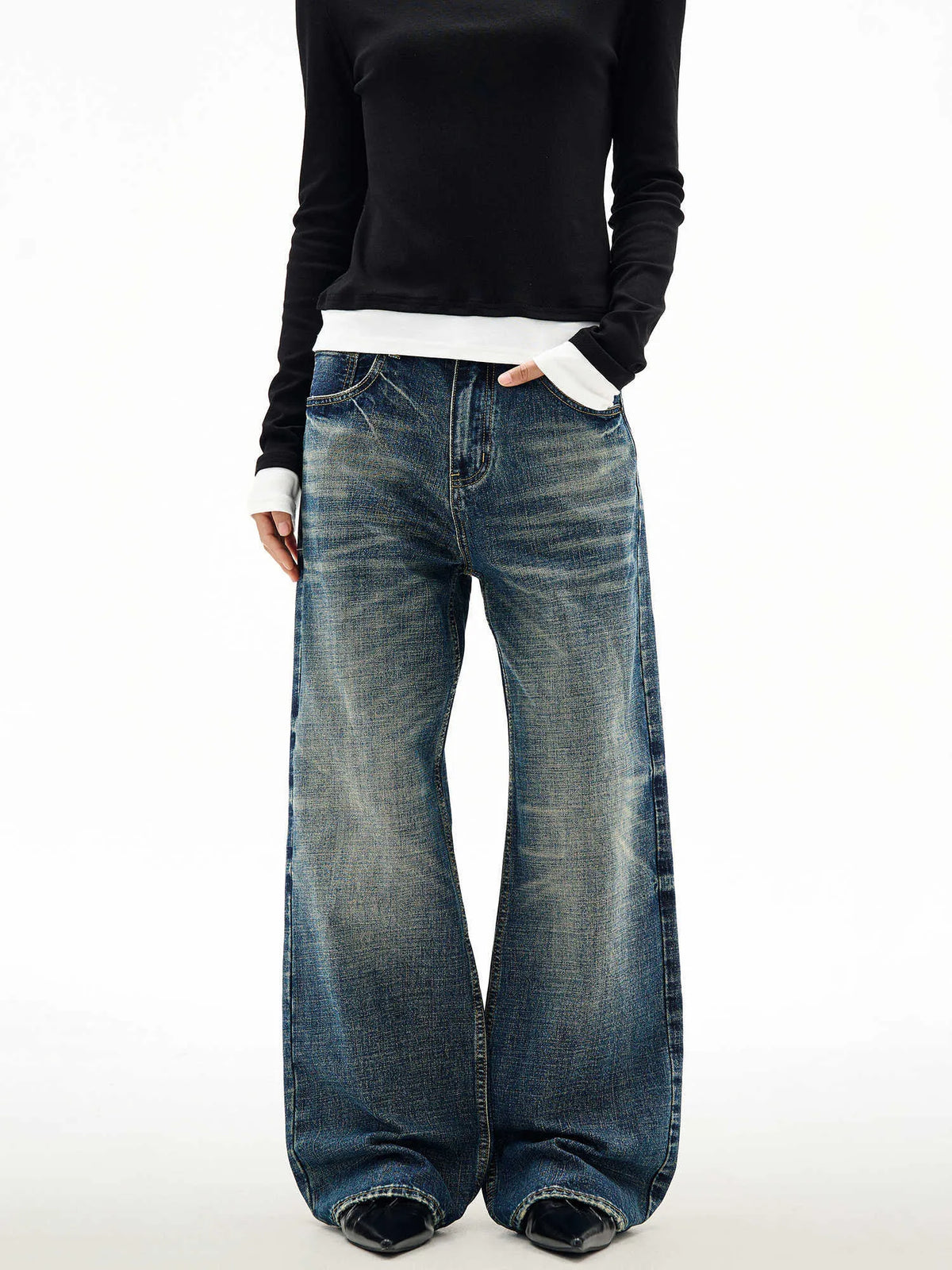 Men's wide leg mid waist jeans in dark blue denim with straight loose cut and distressed cat beard detail