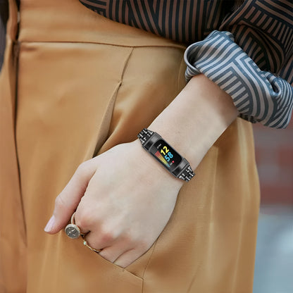 Diamond-patterned metal watch strap for Fitbit Charge 5 in rose gold colour.