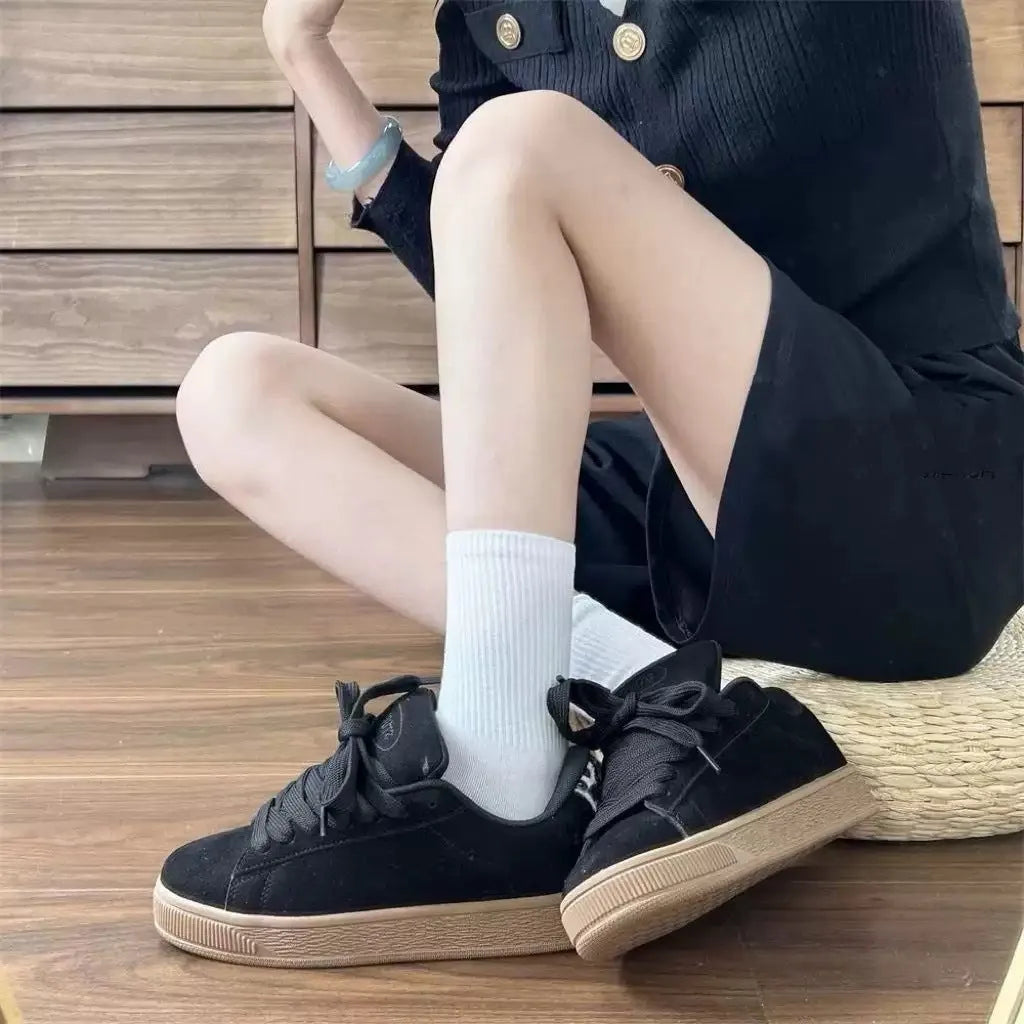 Black retro low-top sneakers with artificial PU upper, round toe and lace-up front closure on rubber sole