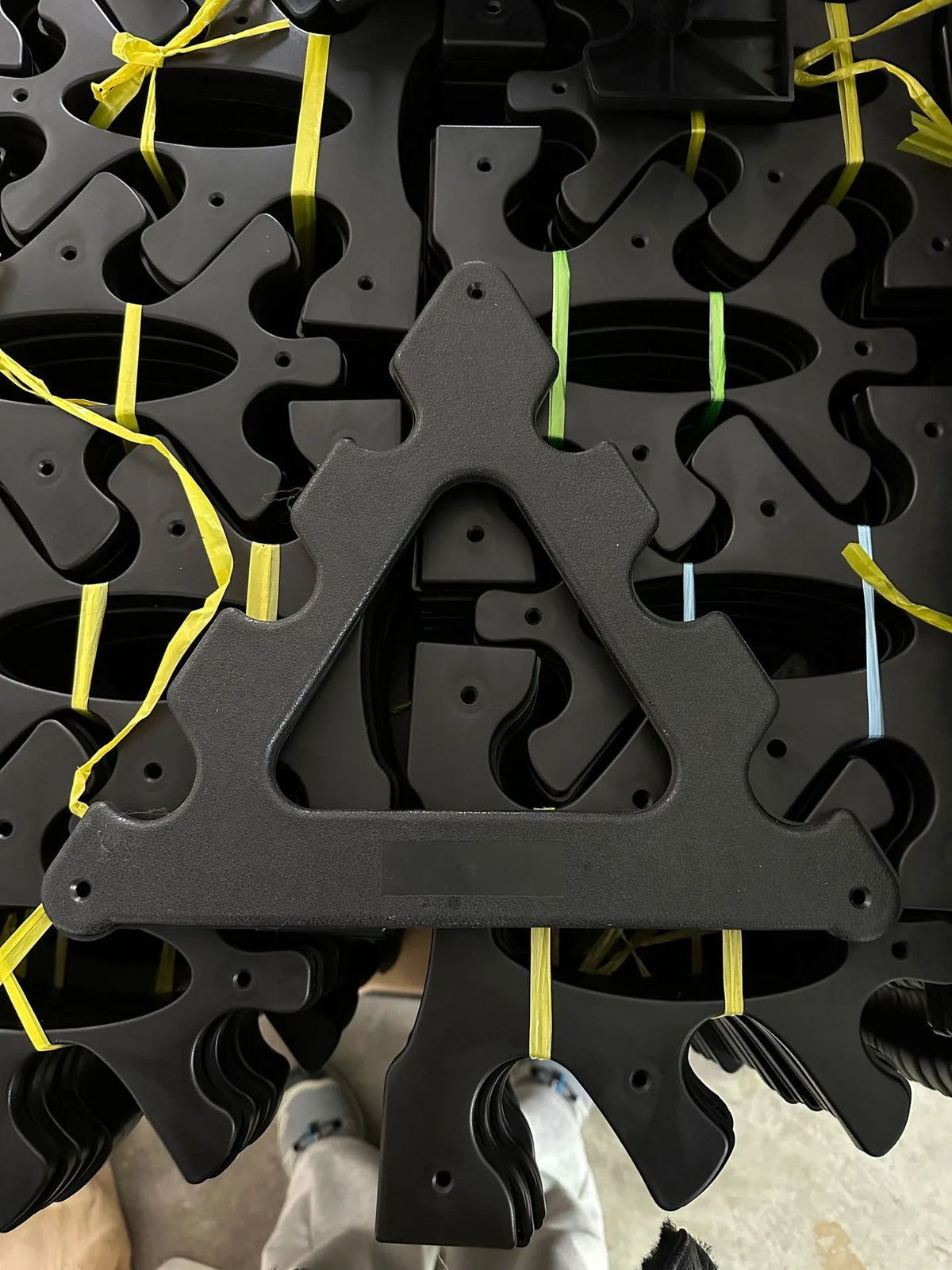 PVC fitness dumbbell rack with removable bracket support on a gym floor