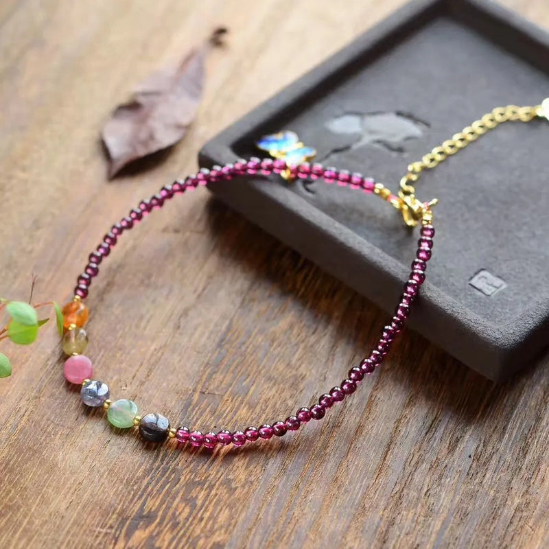 Women's summer anklets crafted from natural garnet beads in an ethnic geometric design, featuring purple gemstone accents for casual wear and festival jewellery