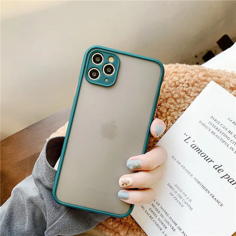 Solid colour silicone shockproof protective case for iPhone models on a table.