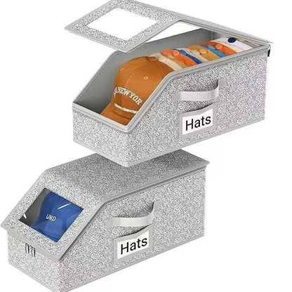 Grey foldable fabric storage box with lid for organising shoes and caps.