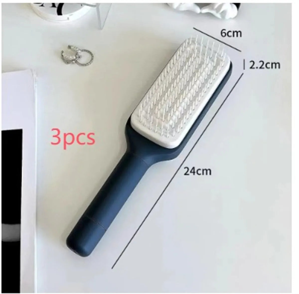Purple and grey self-cleaning hair brush with rotating handle for easy debris removal