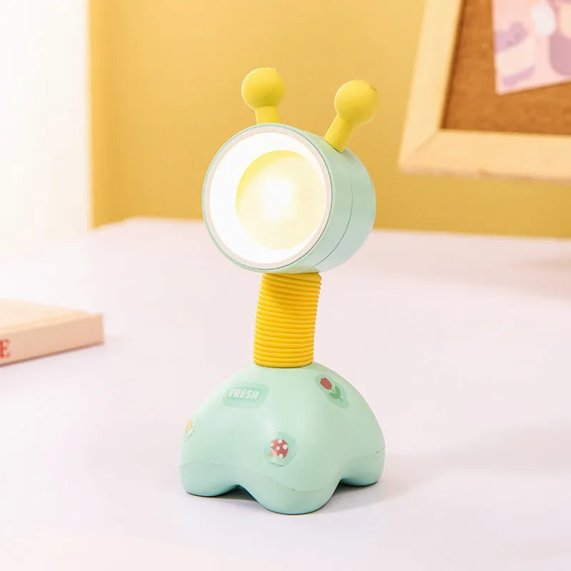Colourful cartoon character magnetic DIY night light on a desk with adjustable head.