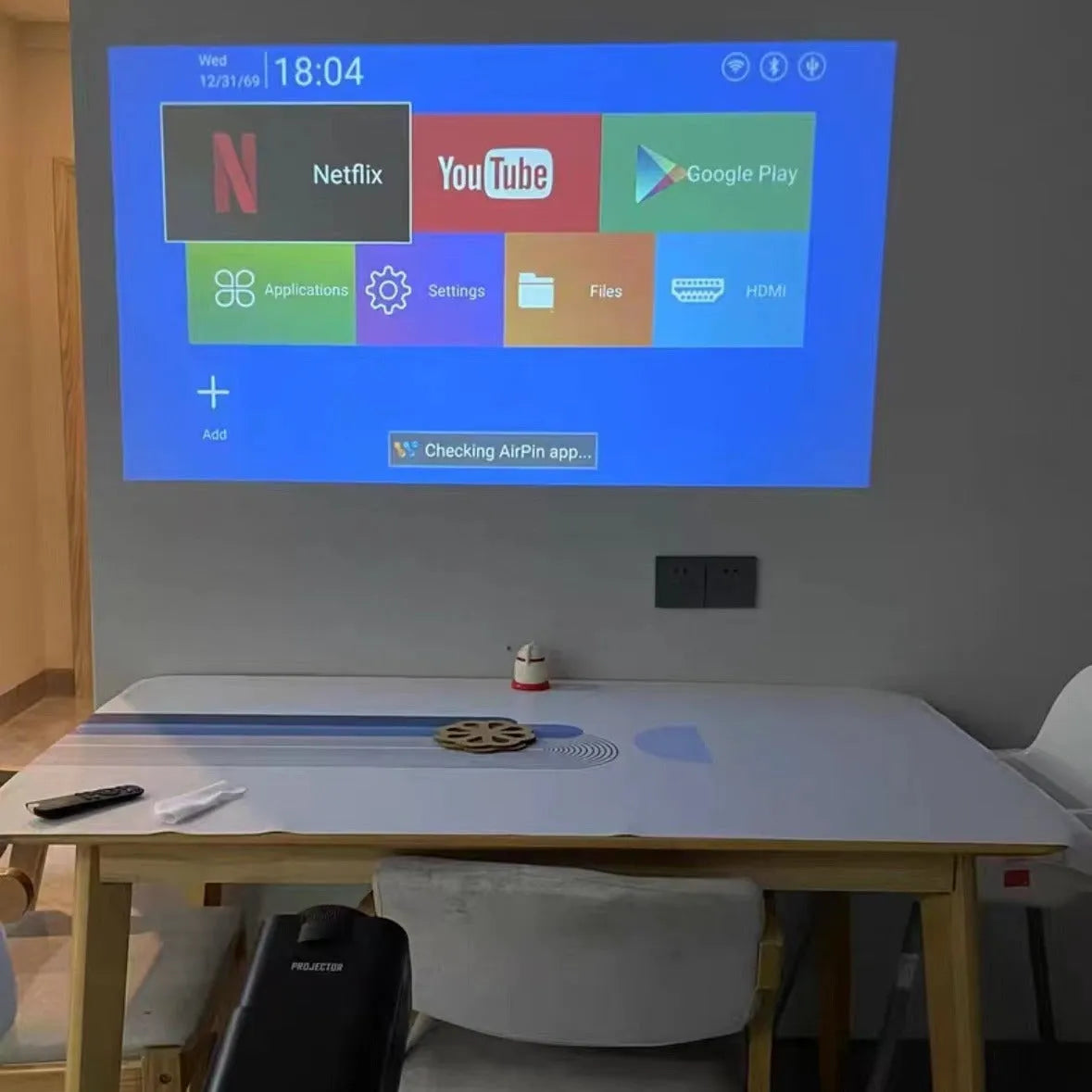 Handheld wireless HD game projector showing 720p resolution for home use.