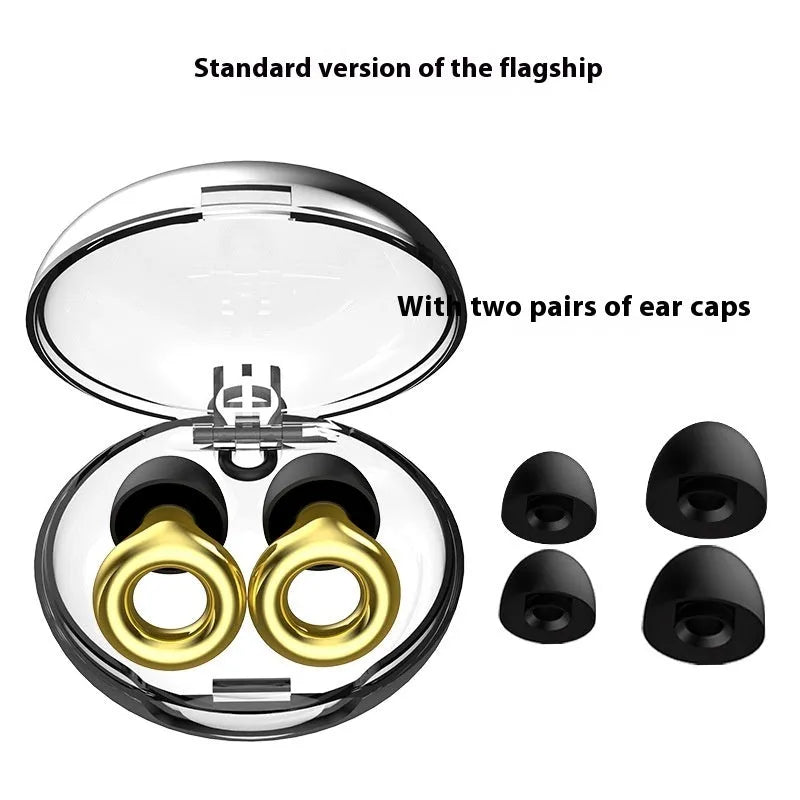 Set of gold-coloured noise reduction earplugs with a storage box and spare ear caps on a white background.