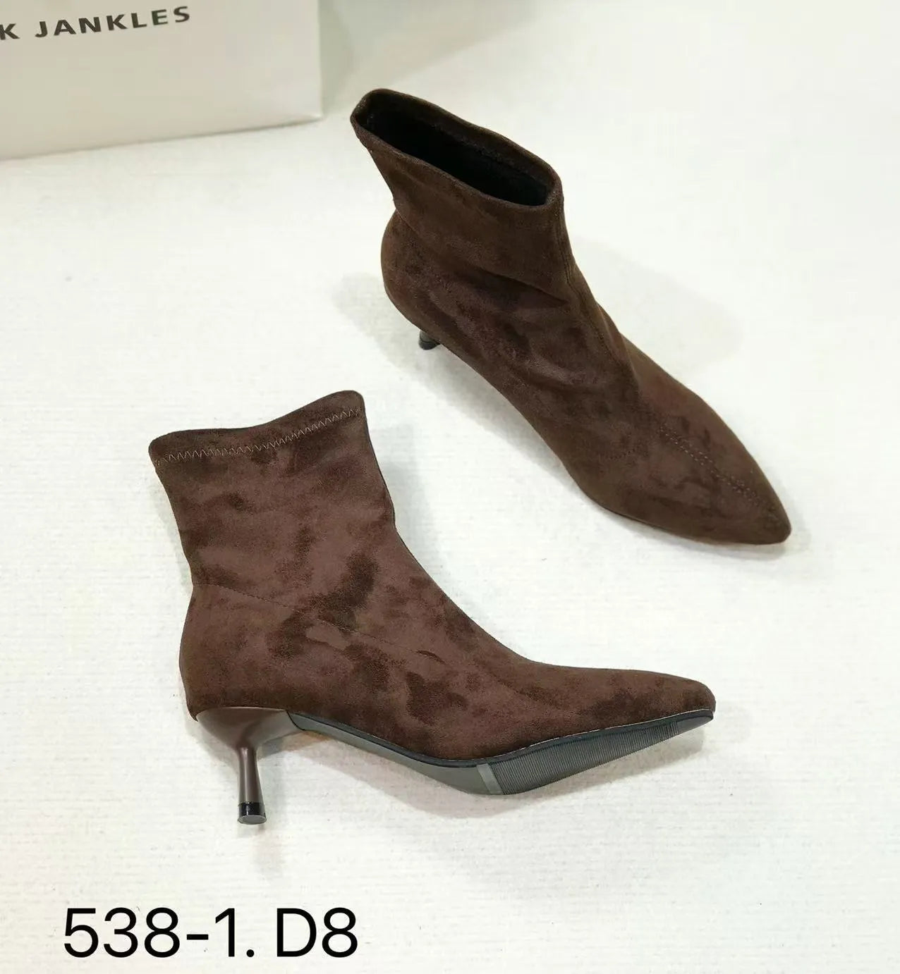 Women's black pointed toe ankle boots with a stiletto heel on a neutral background