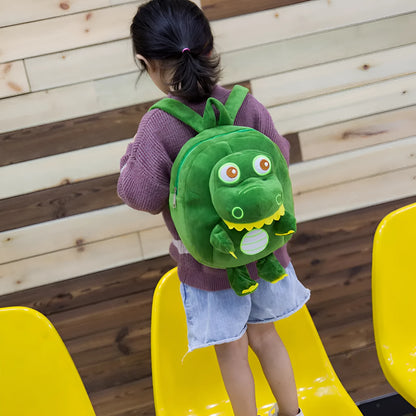 Soft blue plush children's backpack with an embroidered green dinosaur character and a soft handle.