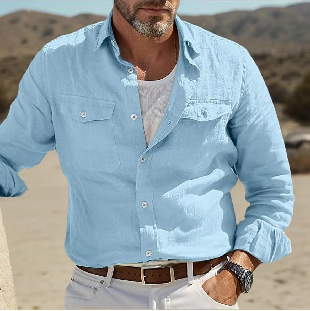 Men's long-sleeved cotton and linen shirt in green, loose fit on a hanger.