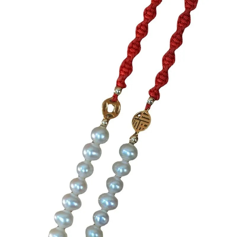 Women's pearl bracelet with braided red rope and geometric fu character charm
