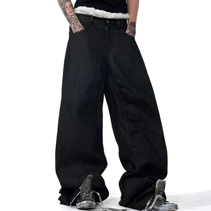 Black wide leg jeans showing loose straight fit and colour-changing embroidered red ear detail.