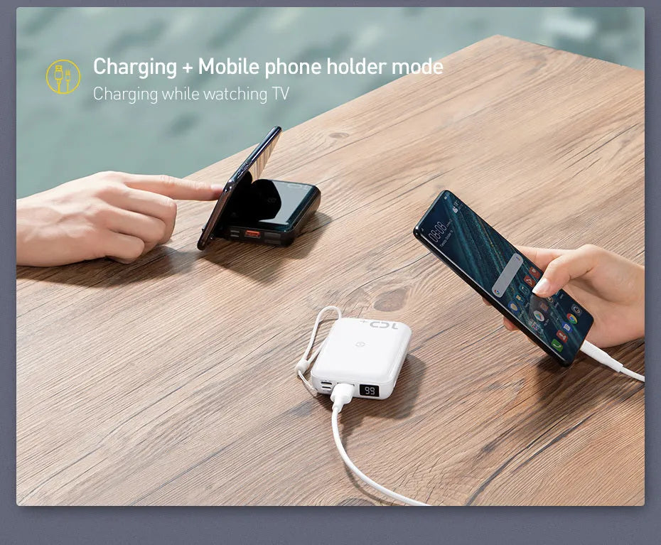 Small square black wireless charging power bank with LED display showing battery percentage.