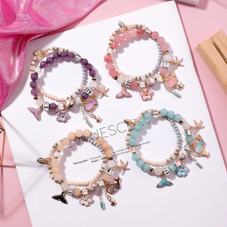 Whale tail bracelet with retro flower and starfish accents, a charming nautical accessory for UK fashionistas