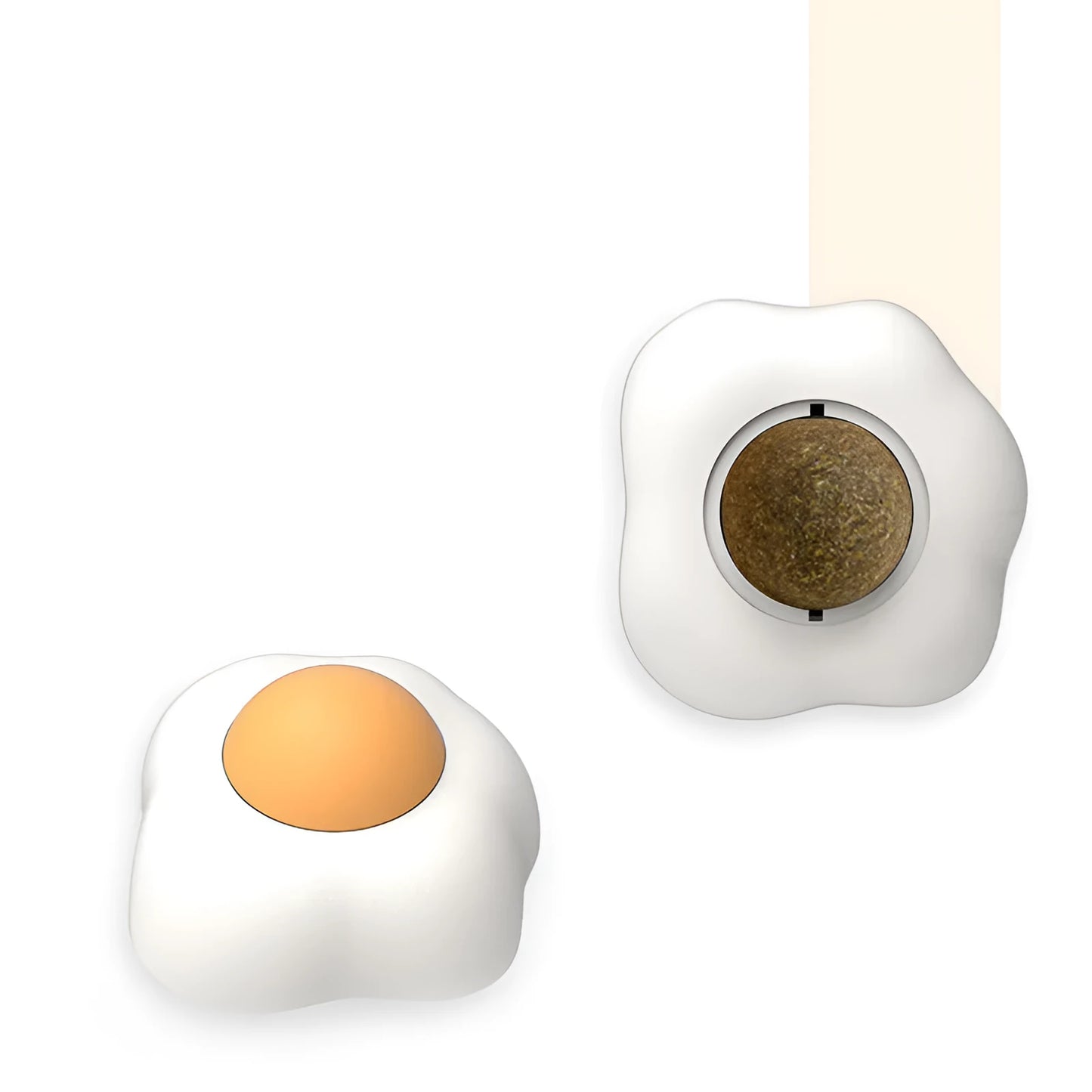 Plush cat toy shaped like a fried egg stuck to a wall, being batted by a cat's paw.