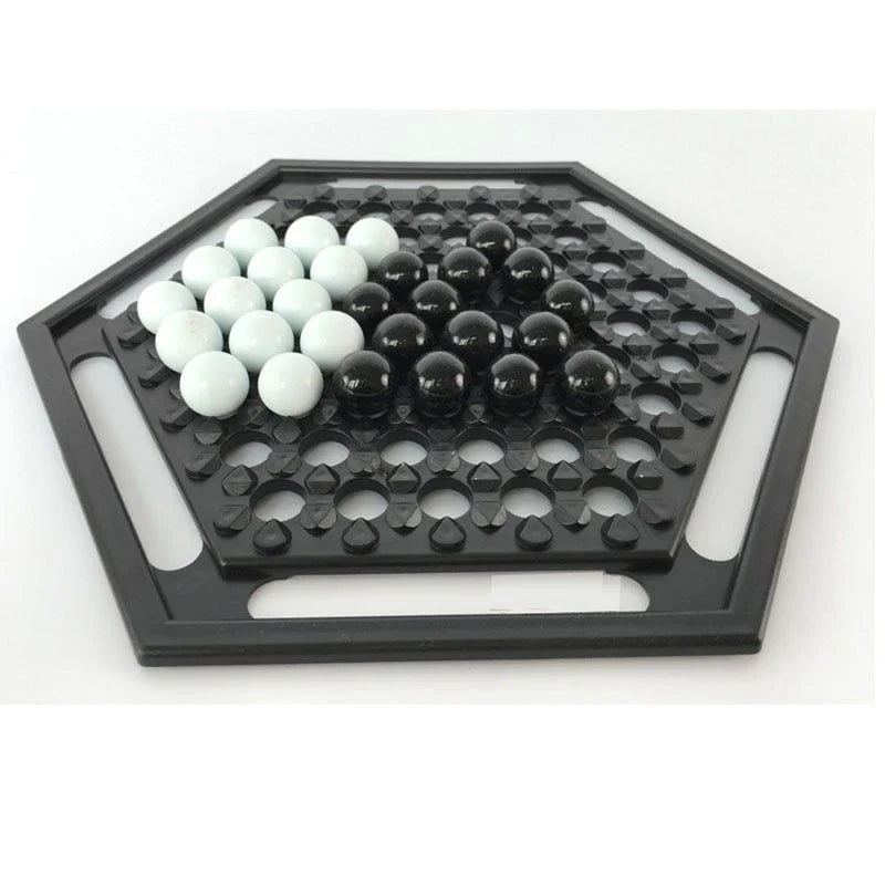 Abalone family board game with marble pieces on a wooden game board