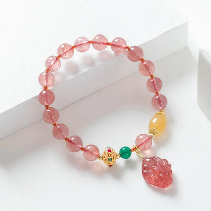 Women's strawberry quartz crystal beaded bracelet with Nine Tail Fox design on wrist