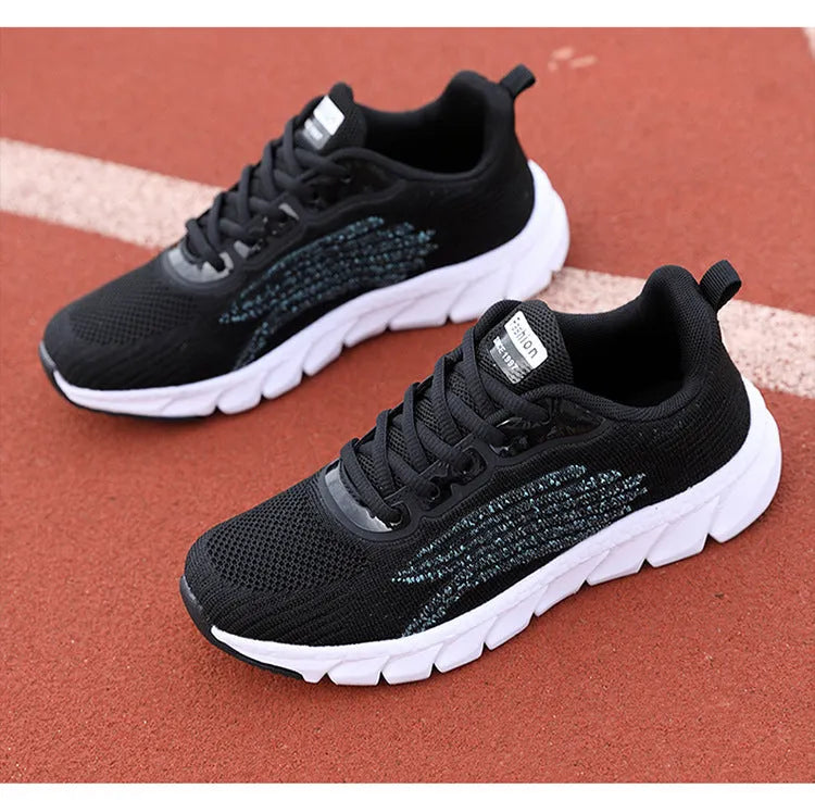 Women's black and white low-top casual running sneakers with round toe and MD soles