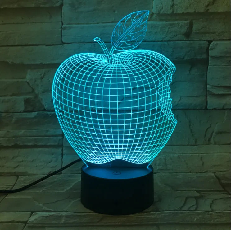 Colourful 3D fruit design LED night light with touch control on a table.
