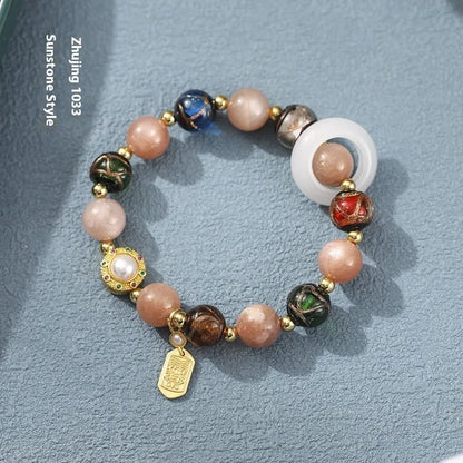 Hand-woven women's bracelet with grey coloured glaze sunstone beads and white lip shell beads