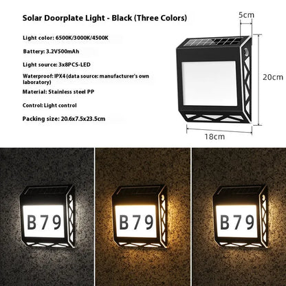 Black solar doorplate light with LED illumination showing house numbers