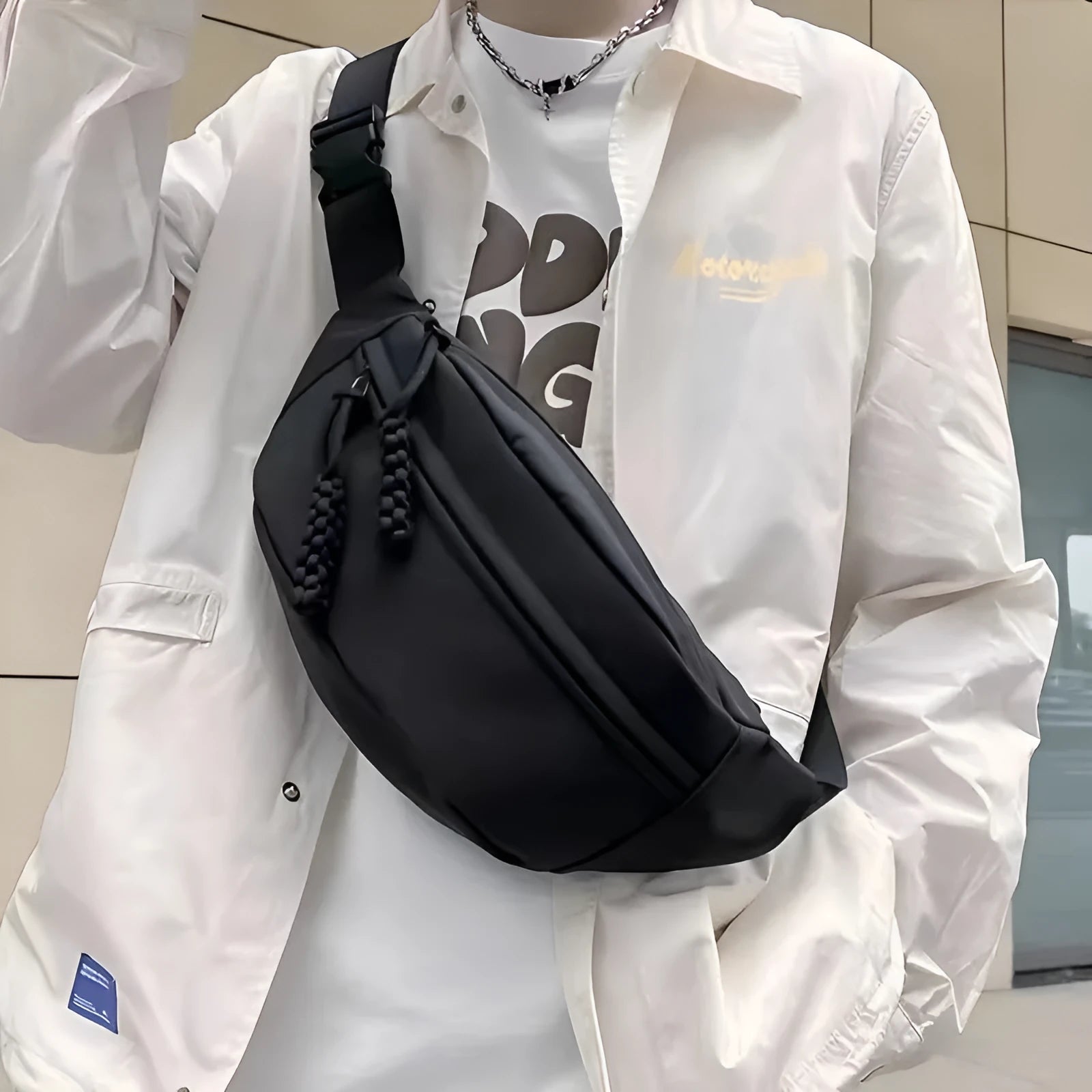 Men's small black polyester crossbody chest bag with adjustable strap.