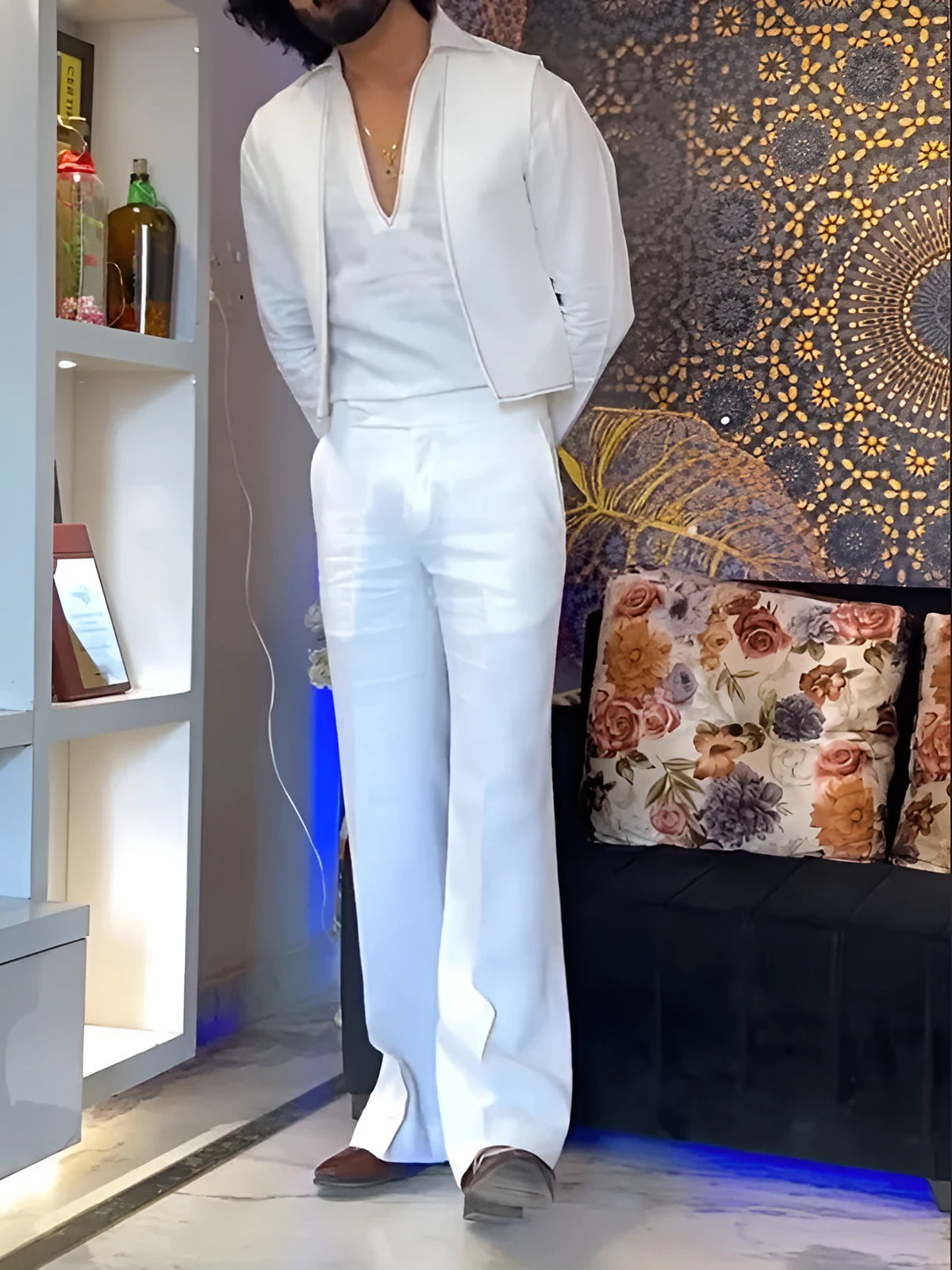 White three-piece outfit with V-neck shirt, sleeveless vest and trousers on hanger