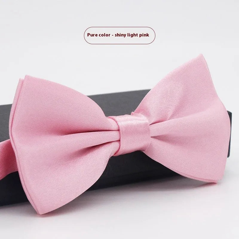 A solid colour pre-tied bow tie with an adjustable neck strap, shown in a classic flat head shape.