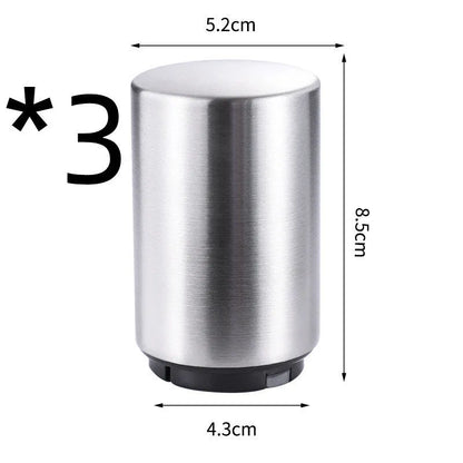 Stainless steel automatic bottle opener measuring 8.4 cm by 5.3 cm on a kitchen counter
