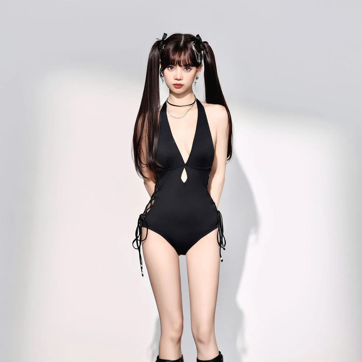 Black women's one-piece swimsuit with V-neck and hollow strap design.