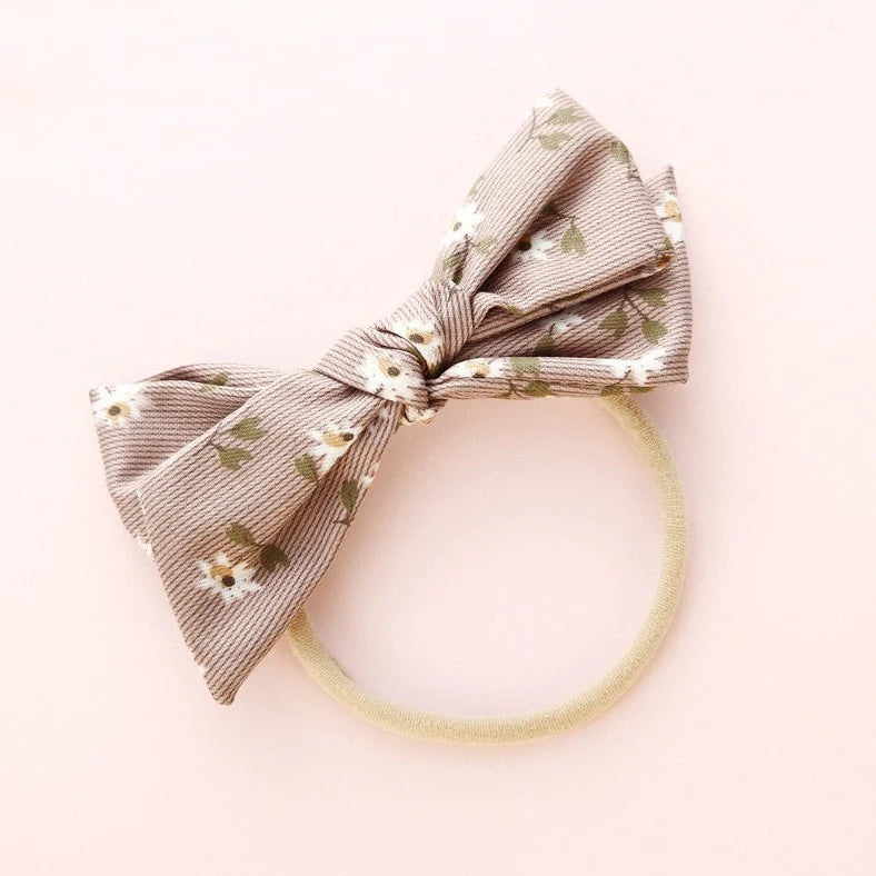 Children's cloth hair band with knotted bow design in one of six colour options