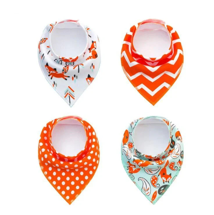 Set of four cotton baby bibs with arrow and wave designs for mess-free feeding
